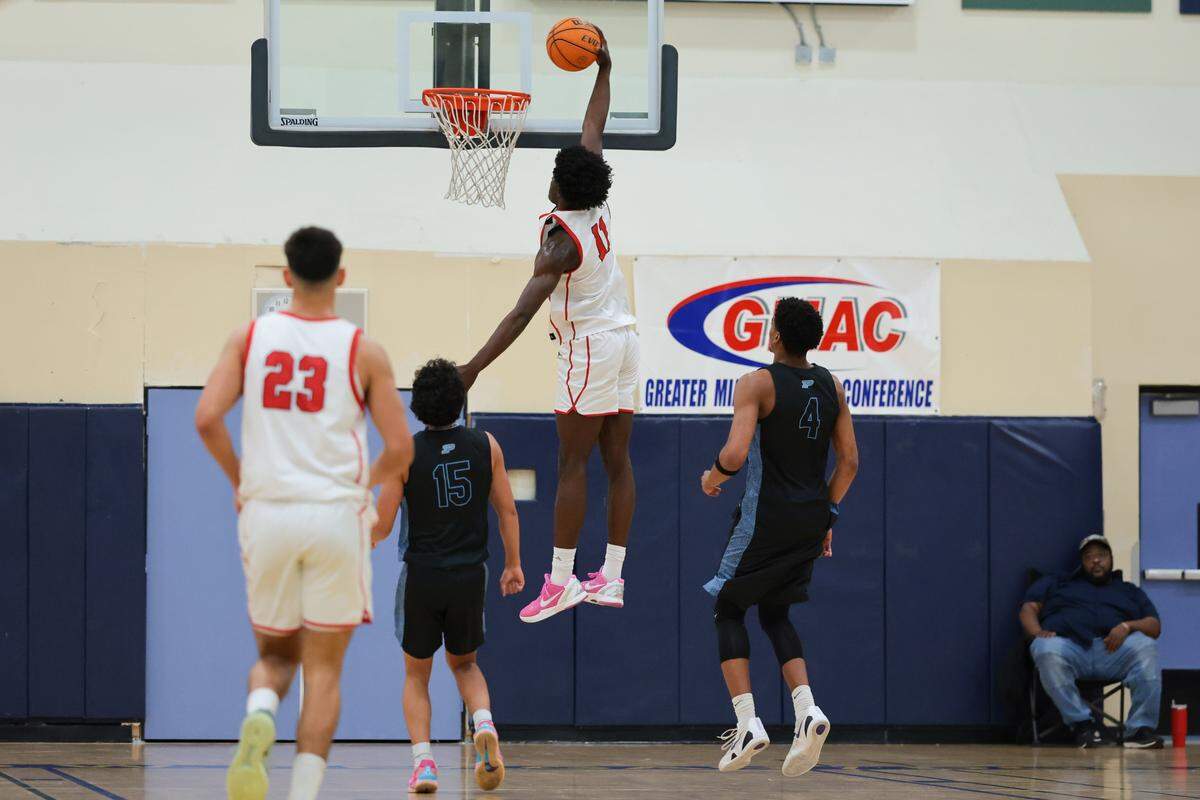 Columbus Explorers forward Caleb Gaskins (11) dunks against the Palmetto Panthers during the first quarter of a Greater Miami Athletic Conference boys basketball finals game at Ronald W. Reagan Doral Senior High School on Saturday, Jan. 24, 2026, in Doral, Fla. 