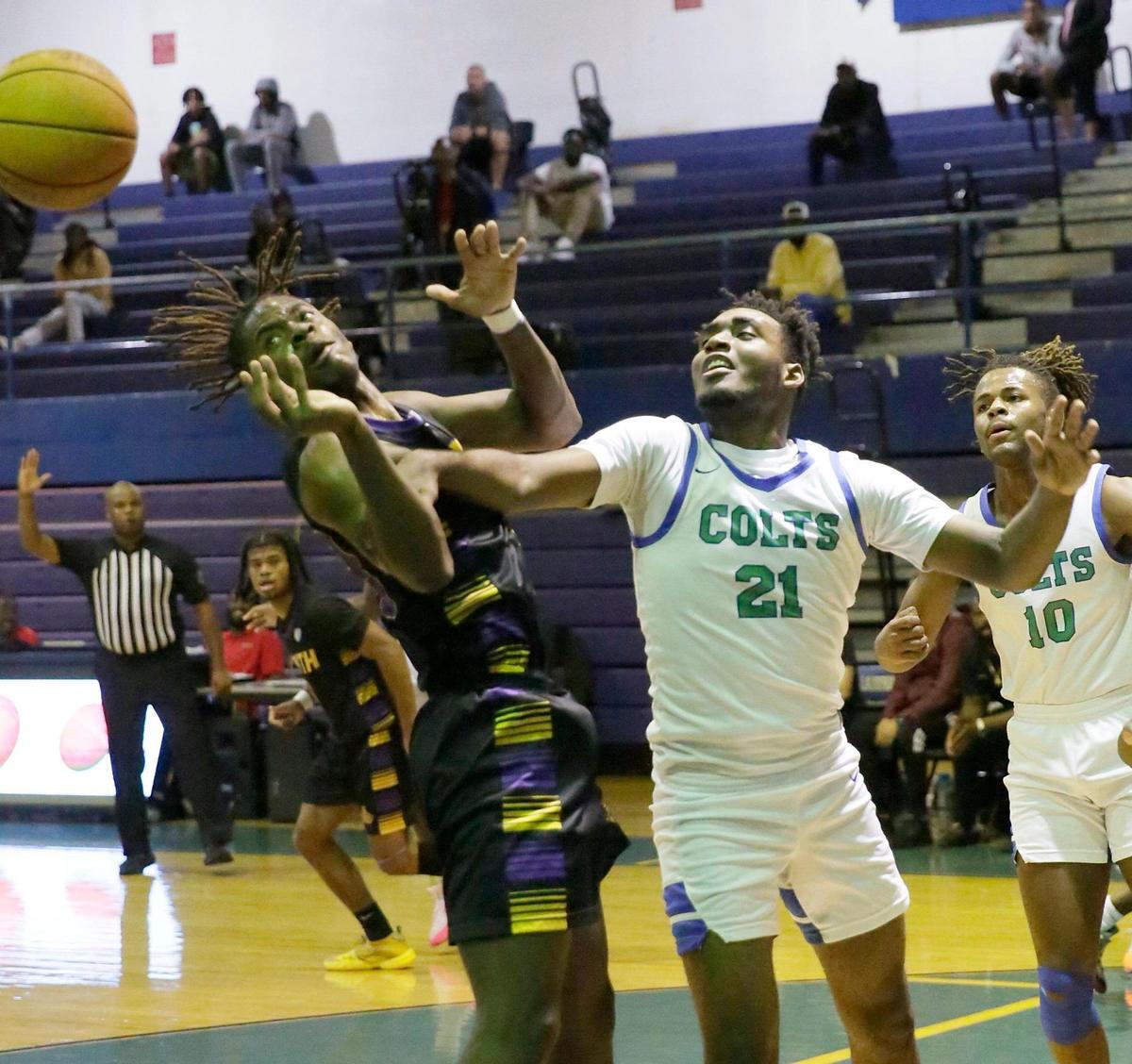 Coral Springs’ Alex Pierre Louis (21) and South Plantation’s Jaymar Previl fight for a rebound during the BCAA Big 8 basketball boys final on Saturday, January 27, 2024 at Fort Lauderdale HS in Fort Lauderdale.