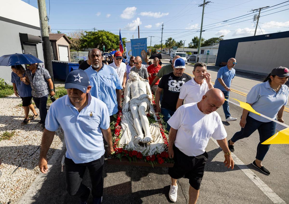 Parishioners carry a statue of Jesus during the Living Stations of the Cross procession near the Cathedral of St. Mary on Friday, April 18, 2025, in Miami, Fla.
