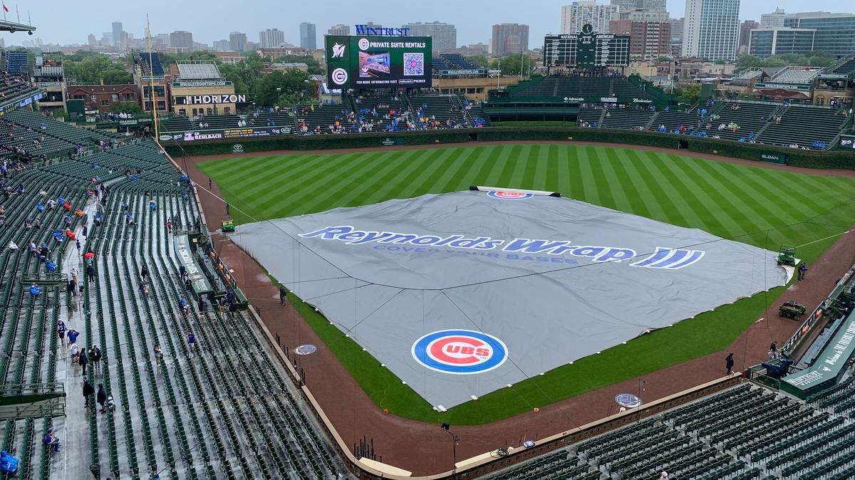 A tarp lies on the Wrigley Field infield on Sunday, Aug. 7, 2021. The Miami Marlins’ series finale against the Chicago Cubs is beginning in a rain delay due to inclement weather.