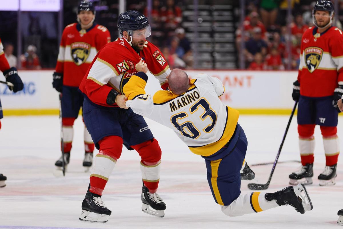 Florida Panthers left wing Jonah Gadjovich (12) fights against Nashville Predators defenseman Kyle Marino (63) during the first period of an NHL preseason game at Amerant Bank Arena in Sunrise, Florida, on Sunday, September 22, 2024.
