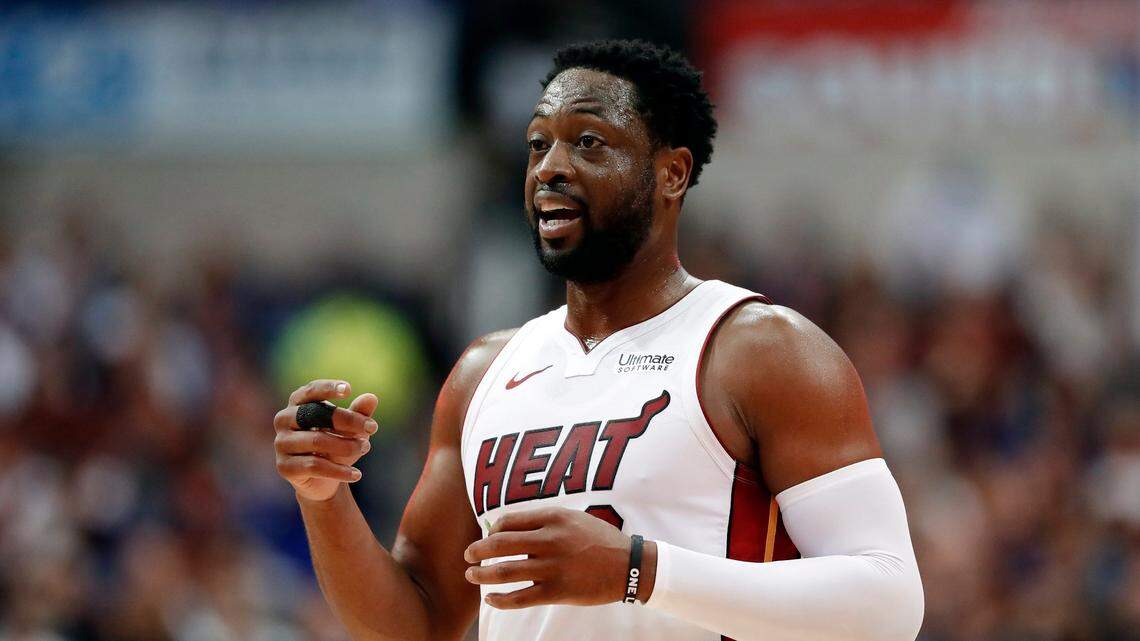 Miami Heat guard Dwyane Wade talks to a teammate during a timeout in the first half of the team’s NBA basketball game against the Dallas Mavericks in Dallas, Wednesday, Feb. 13, 2019. (AP Photo/Tony Gutierrez)
