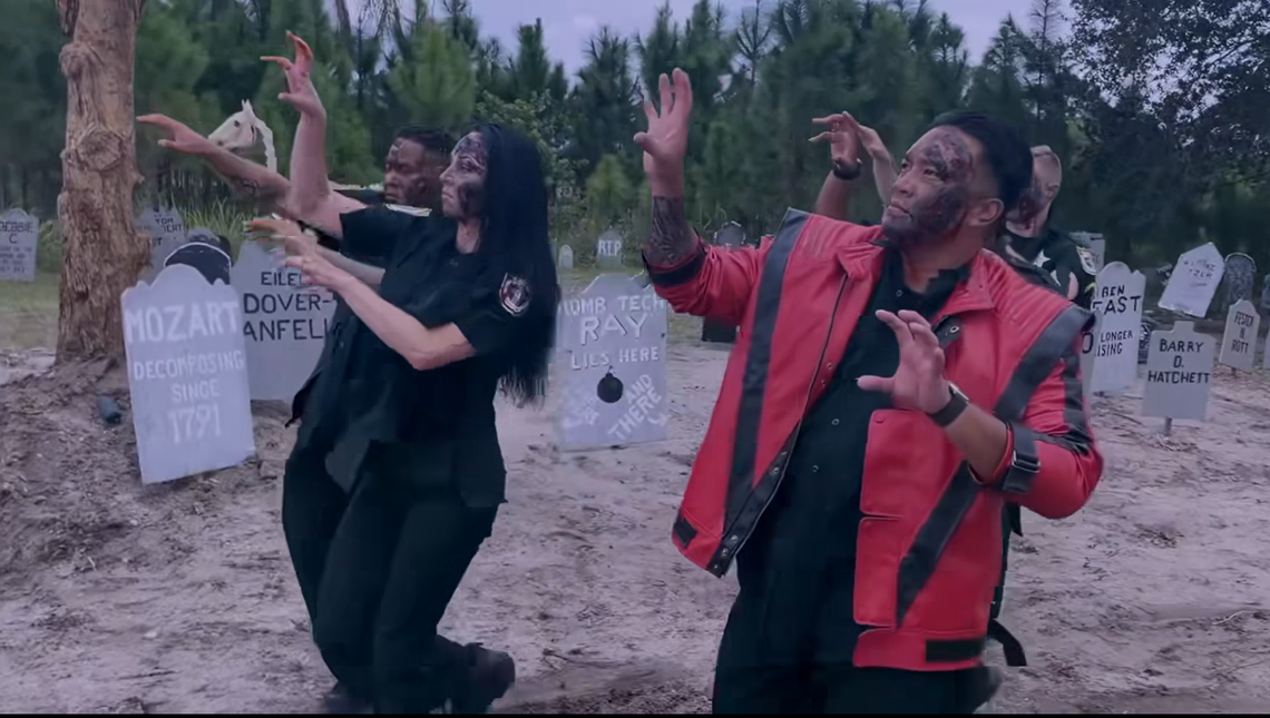 Corporal Gaston Robin leads the group, wearing a classic Michael Jackson red leather jacket and zombie makeup. His dance team includes agent Candice Watson, Ashley Jennings and Anthony McDonough, with Corporal Miguel Melendez.
