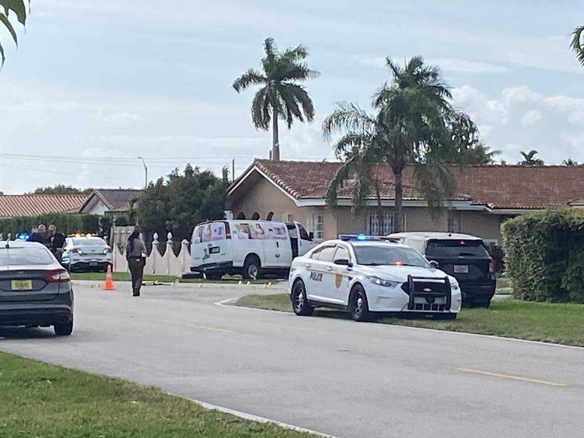 A van is parked in a yard atSouthwest 97th Avenue and 21st Street Friday, Dec. 8, 2023, after it was hit by a pickup truck. Two people in the van were critically injured, police said, and one person in the pickup truck died.
