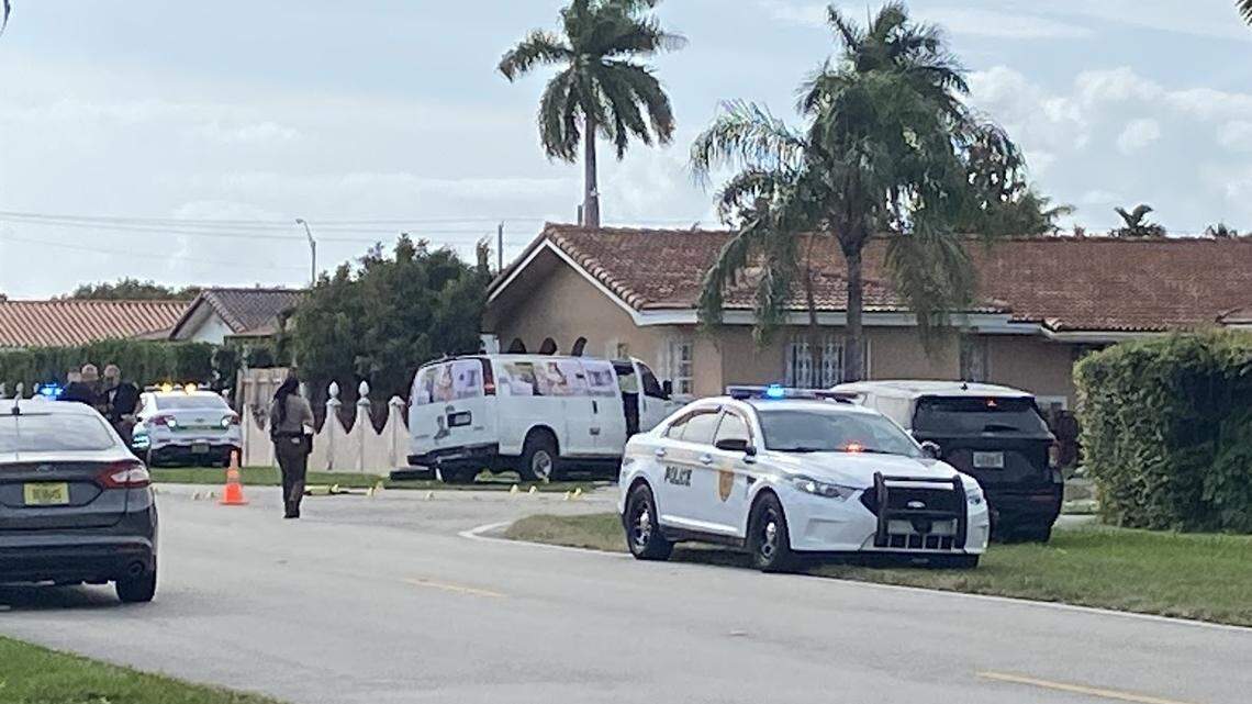 A van is parked in a yard atSouthwest 97th Avenue and 21st Street Friday, Dec. 8, 2023, after it was hit by a pickup truck. Two people in the van were critically injured, police said, and one person in the pickup truck died.