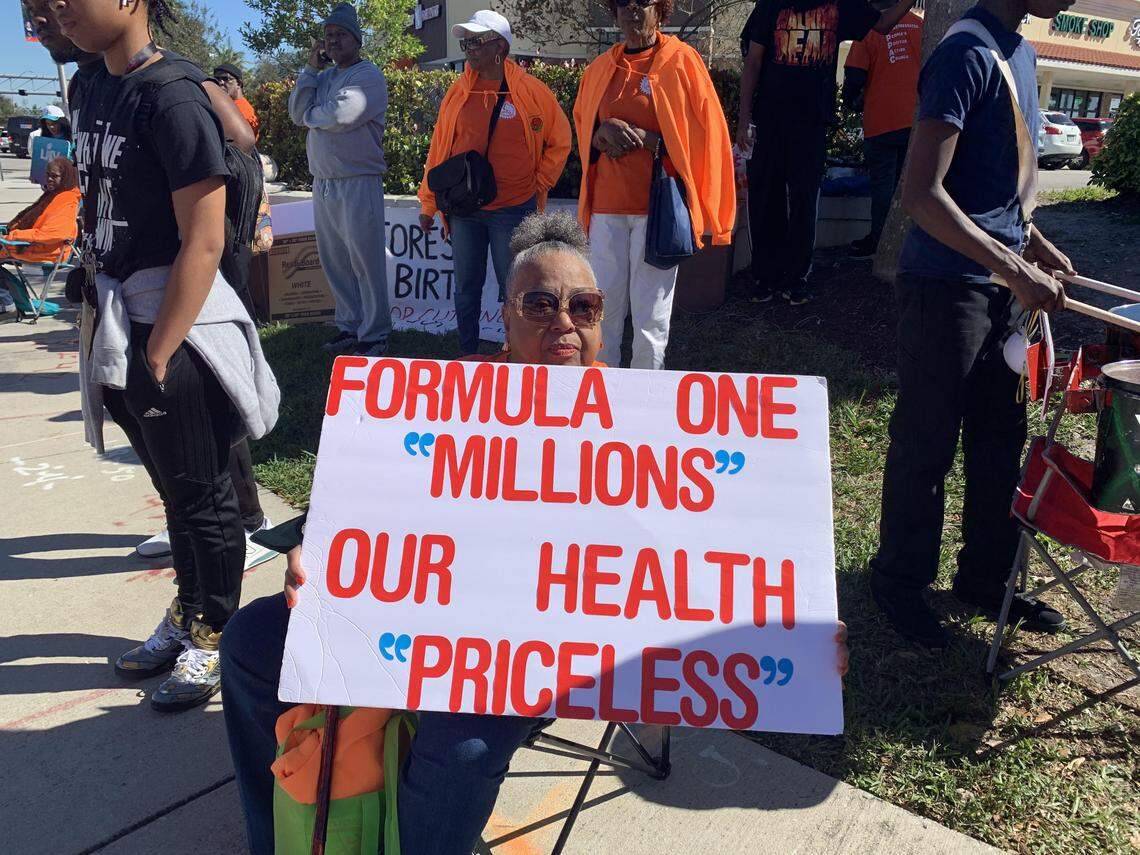 Former Miami-Dade County Commissioner Betty Ferguson holds a sign at a protest outside the Super Bowl.