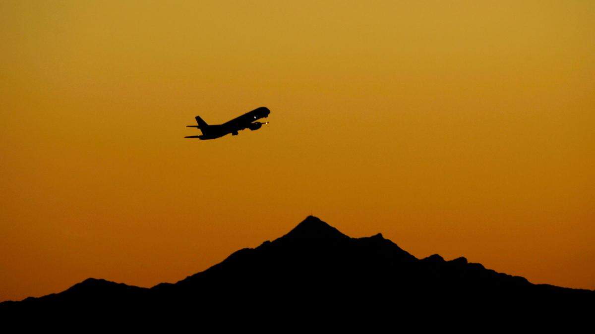 In this stock photo, an airplane takes off at sunset from Sky Harbor International Airport, Friday, Feb. 1, 2008, in Phoenix.
