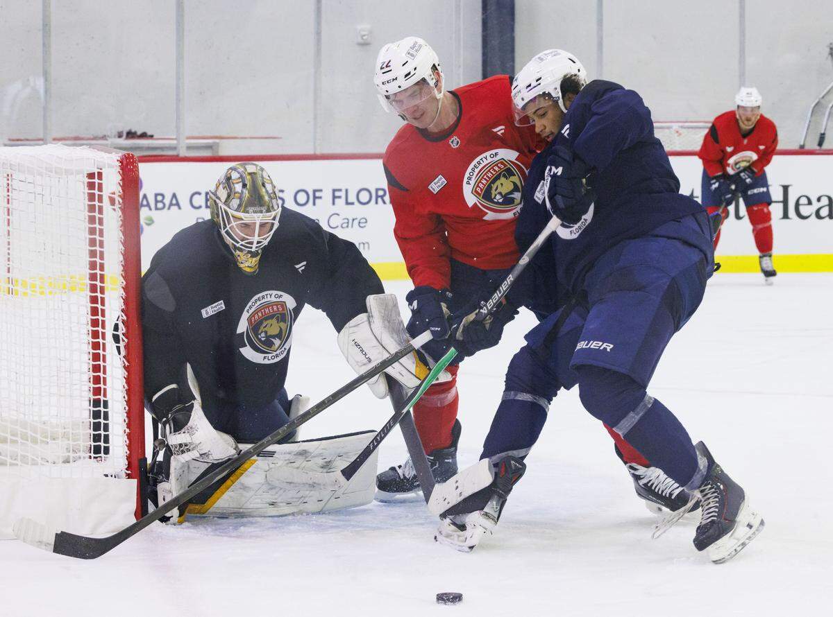 Defenseman Tobias Bjornfot (22) and Goaltender Brandon Bussi (30) block a shot by Forward Shamar Moses (34) during the first practice of Florida Panthers training camp on Thursday, Sept. 18, 2025, at Baptist Health IcePlex in Fort Lauderdale, Fla. 