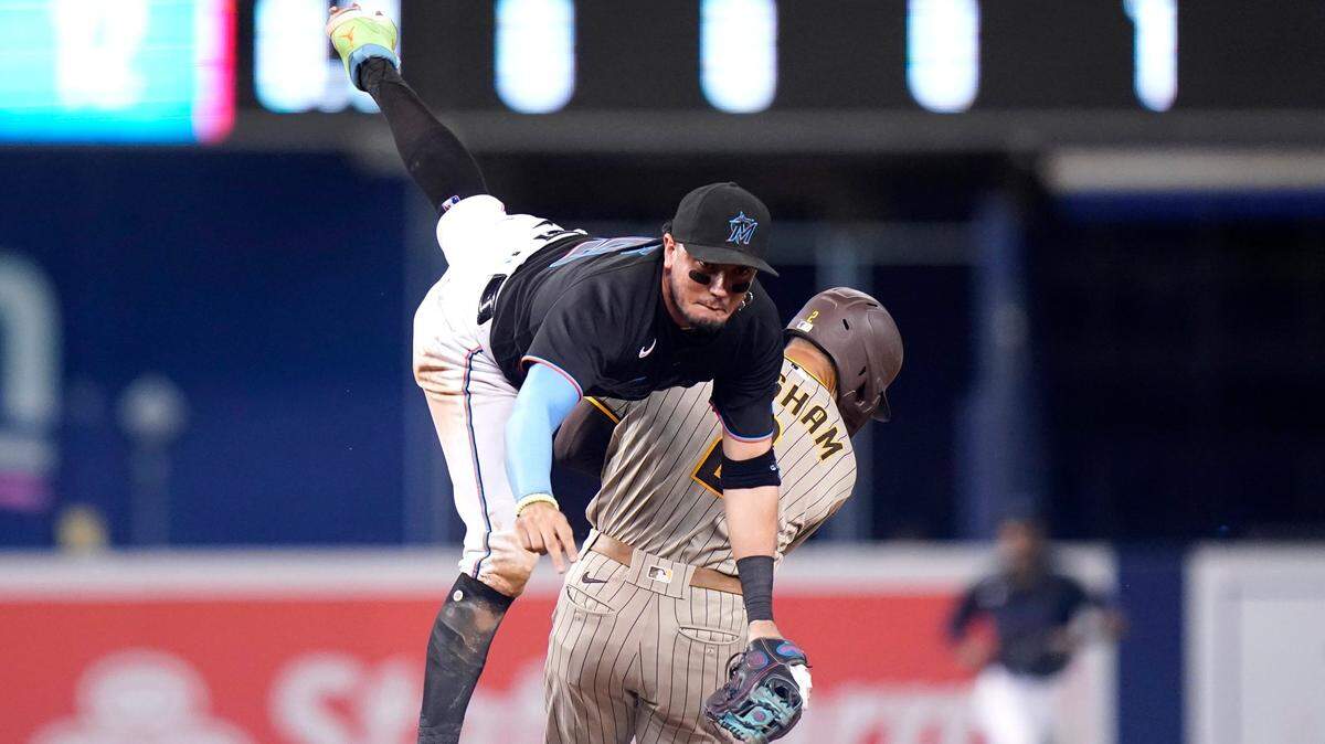 Miami Marlins shortstop Miguel Rojas, left, collides with San Diego Padres’ Trent Grisham, right, who was out at second on runner’s interference during the ninth inning of a baseball game, Saturday, July 24, 2021, in Miami. (AP Photo/Lynne Sladky)