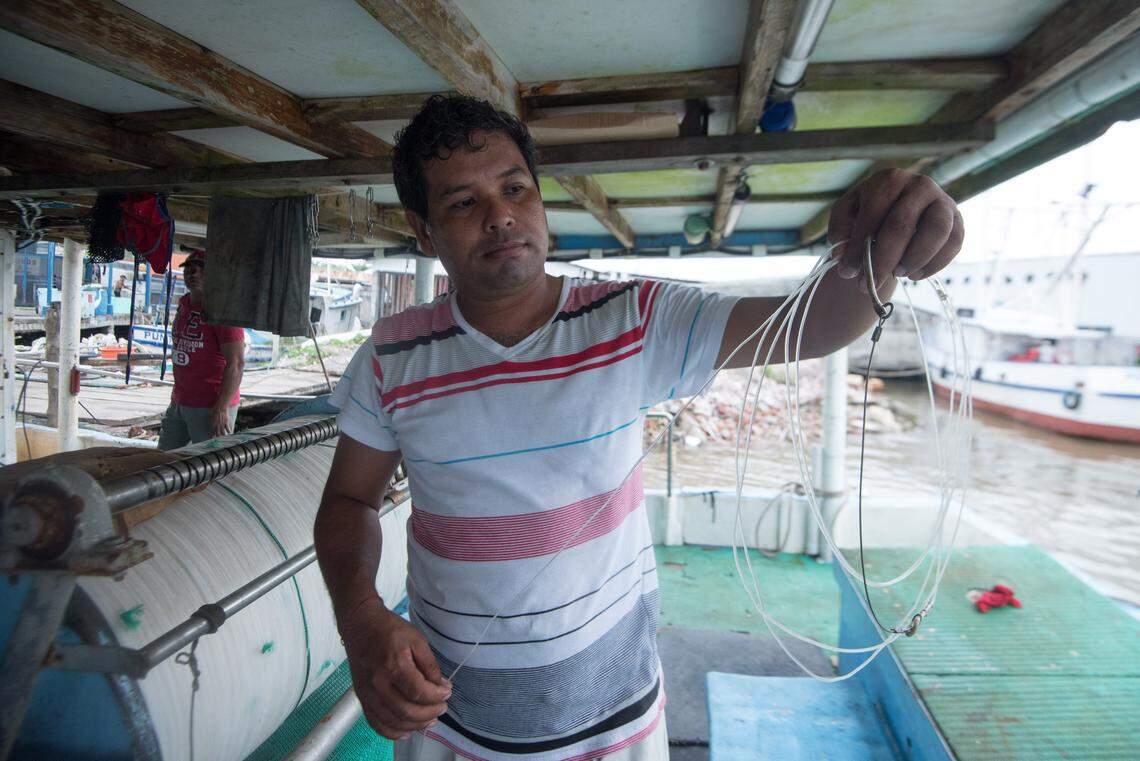 Sergio Soto Peña shows the hooks used for fishing sharks with a longline.