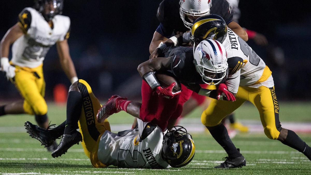 Chaminade’s Jordan Cash (4) WR is taken down by American Heritage’s Omar Simpson (22) during the second quarter at Chaminade-Madonna College Prep in Hollywood on Friday, Sept. 21, 2018.