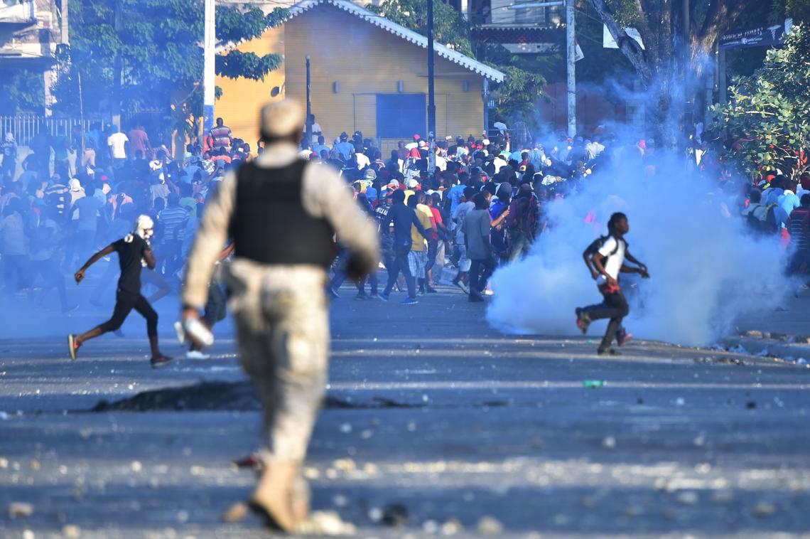 Haitian police clash with demonstrators, near to the National Palace, in the center of Port-au-Prince, February 13, 2019, on the seventh day of protests against Haitian President Jovenel Moise and the misuse of the oil-discount PetroCaribe program from Venezuela.