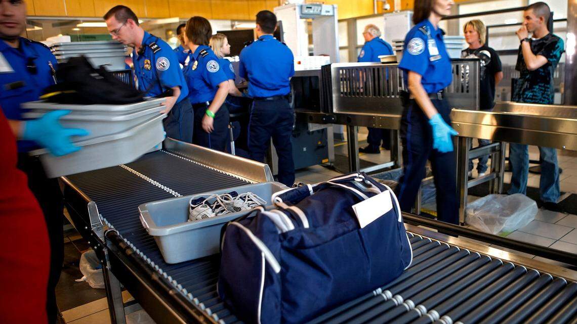 TSA agents help travelers move through a security checkpoint at Will Rogers World Airport in Oklahoma City, Friday, August 12, 2011. Photo by Bryan Terry, The Oklahoman ORG XMIT: KOD

Photo 2 Copy
