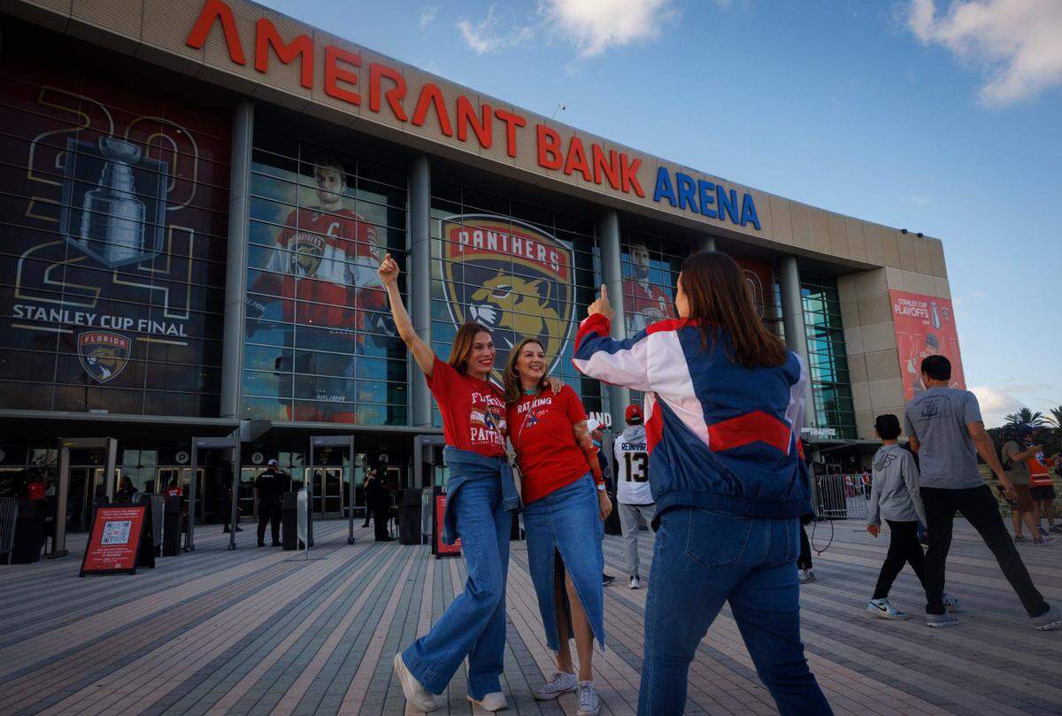 Florida Panthers fans smile for photos before Game 5 of the NHL Stanley Cup Final at the Amerant Bank Arena.