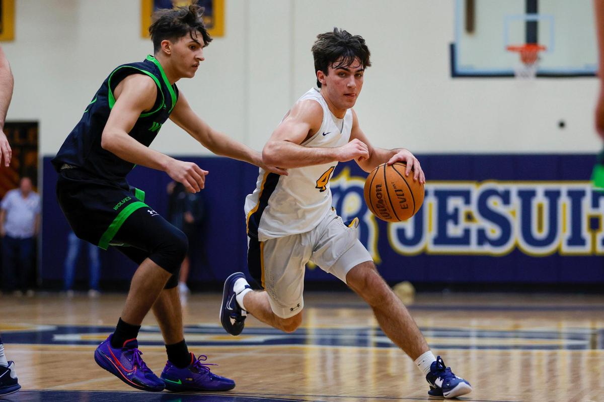 Belen Jesuit guard Javi Rosell (4) drives to the basket as TERRA guard Jordan Del Rio (3) defends during the first quarter of a basketball Region 4-5A quarterfinal game at Belen Jesuit Preparatory School in Miami, Florida on Thursday, February 16, 2023.