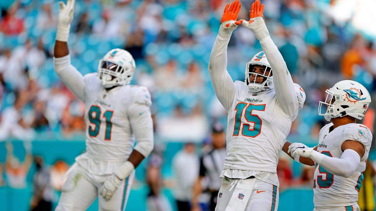 Miami Dolphins defensive end Emmanuel Ogbah (91) and outside linebacker Jaelan Phillips (15) react after sacking Houston Texans quarterback Tyrod Taylor (5) during third quarter of an NFL football game at Hard Rock Stadium on Sunday, November 7, 2021 in Miami Gardens, Florida.