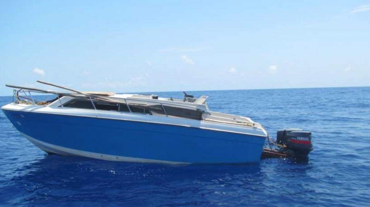 A migrant vessel is shown in the Caribbean after an interdiction in April 2019. The Coast Guard Cutter Spencer crew transferred 33 Haitian nationals back to their home of origin on April 12 after stopping their 25-foot motor vessel on April 10.