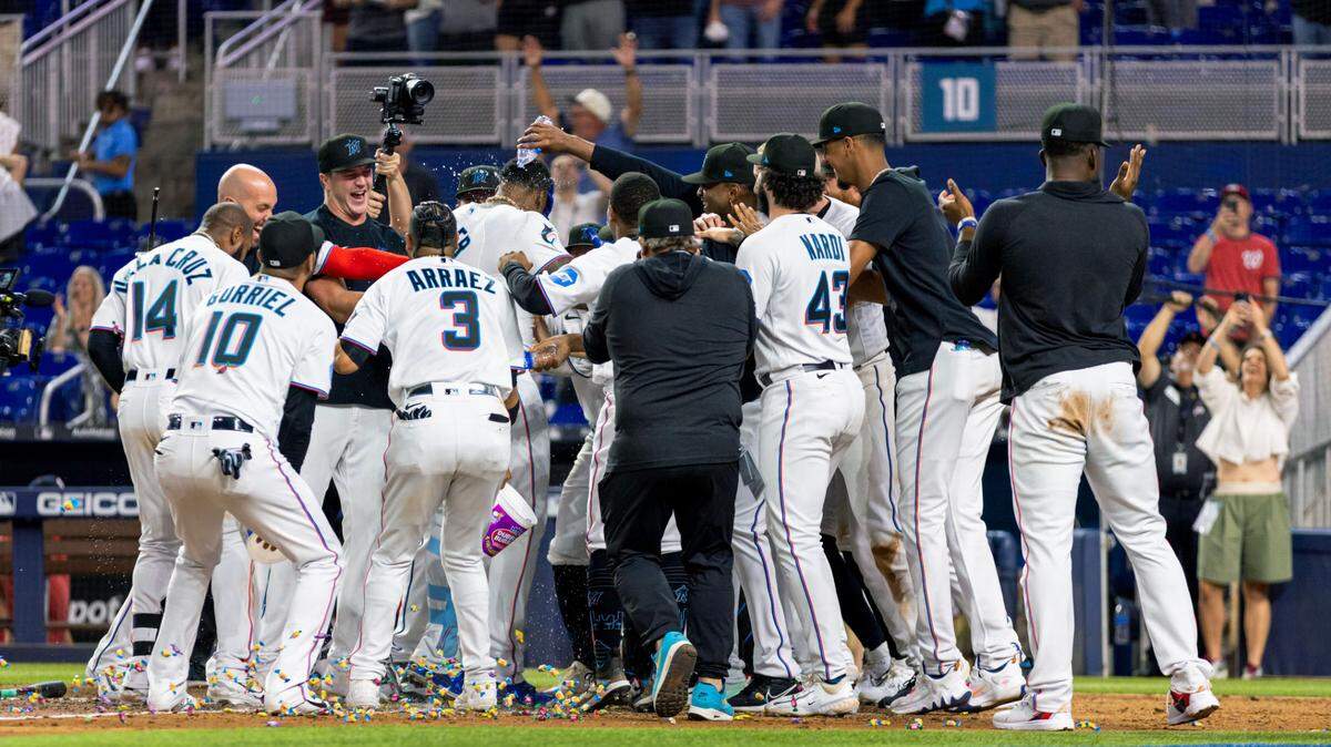 Miami Marlins players greet designated hitter Jorge Soler (12) at home plate after he hit a walk-off two-run homerun to defeat the Washington Nationals 5-4 during the ninth inning of an MLB game at loanDepot park in the Little Havana neighborhood of Miami, Florida, on Tuesday, May 16, 2023.
