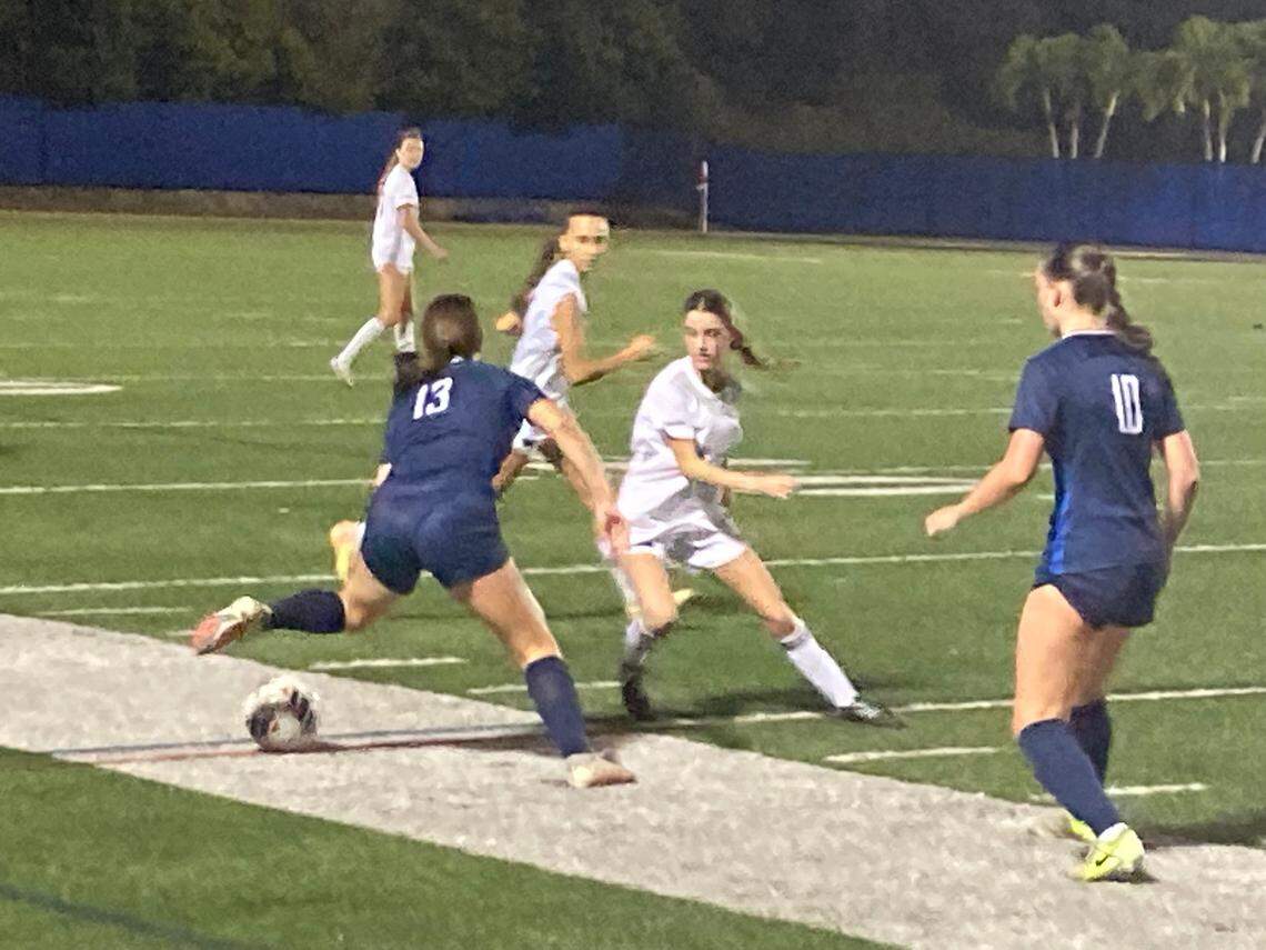 University School’s Mia Herrera (13) tries to advance the ball up the field past Gulliver defenders during Friday’s Region 4-3A girls’ soccer semifinal at AutoNation Field in Davie, Fla.