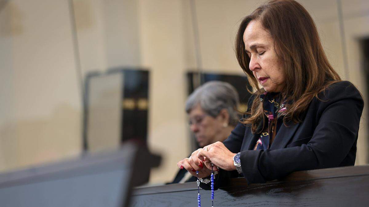 A congregant prays prior to the 10 a.m. Sunday Mass led by Reverend Israel Mago, one day after the United States attacked Venezuela and captured Venezuelan leader Nicolás Maduro and his wife, Cilia Flores, on Sunday, January 4, 2026, in Doral, Florida.