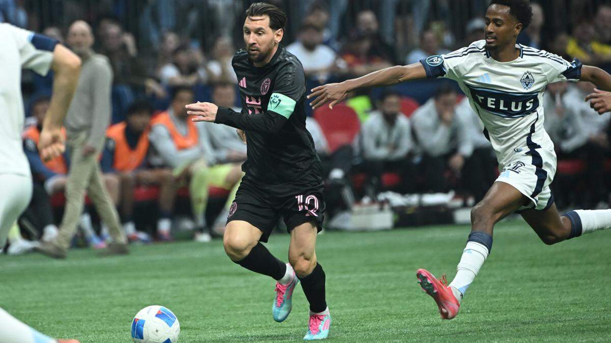 Apr 24, 2025; Vancouver, British Columbia, CAN; Vancouver Whitecaps FC midfielder Ali Ahmed (22) reaches out to grab Inter Miami SC forward Lionel Messi (10) during the first half at BC Place. Mandatory Credit: Simon Fearn-Imagn Images