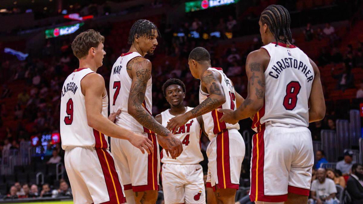Miami Heat players Pelle Larsson (9), Kel’el Ware (7), Isaiah Stevens (4), Keshad Johnson (16) and Josh Christopher (8) huddle during the second half of an NBA preseason game at Kaseya Center on October 16, 2024, in Miami.