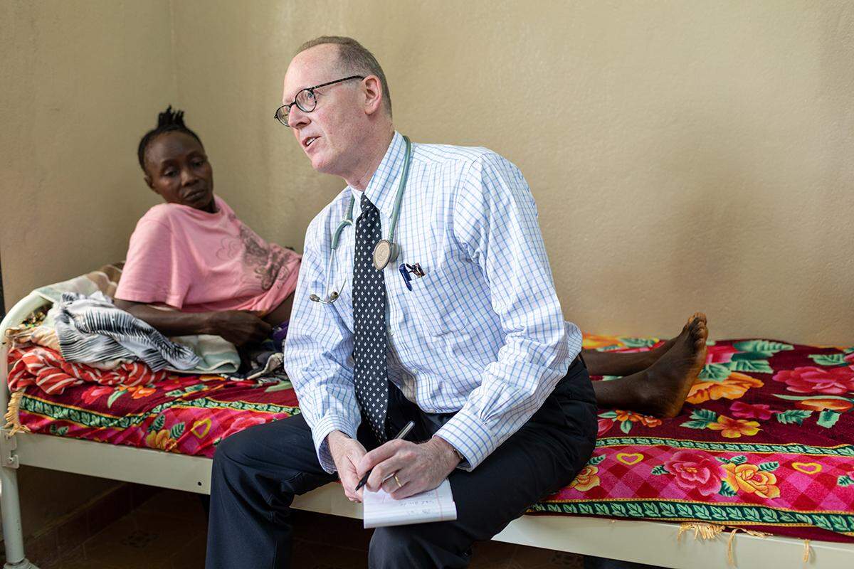 Partners In Health co-founder and chief strategist Dr. Paul Farmer consults on cases for patients like Yie Hawa Missah on July 3, 2019. Missah was suffering from acute onset paralysis at PIH-supported Koidu Government Hospital in Kono District, Sierra Leone.