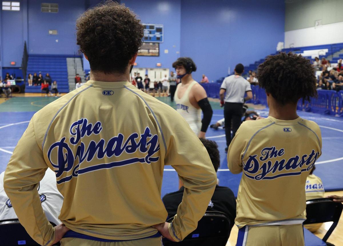 South Dade junior and wrestling standout Sawyer Bartelt, 17, left, watches as teammate bring the victory during regional tournament on Thursday, January 12, 2023.