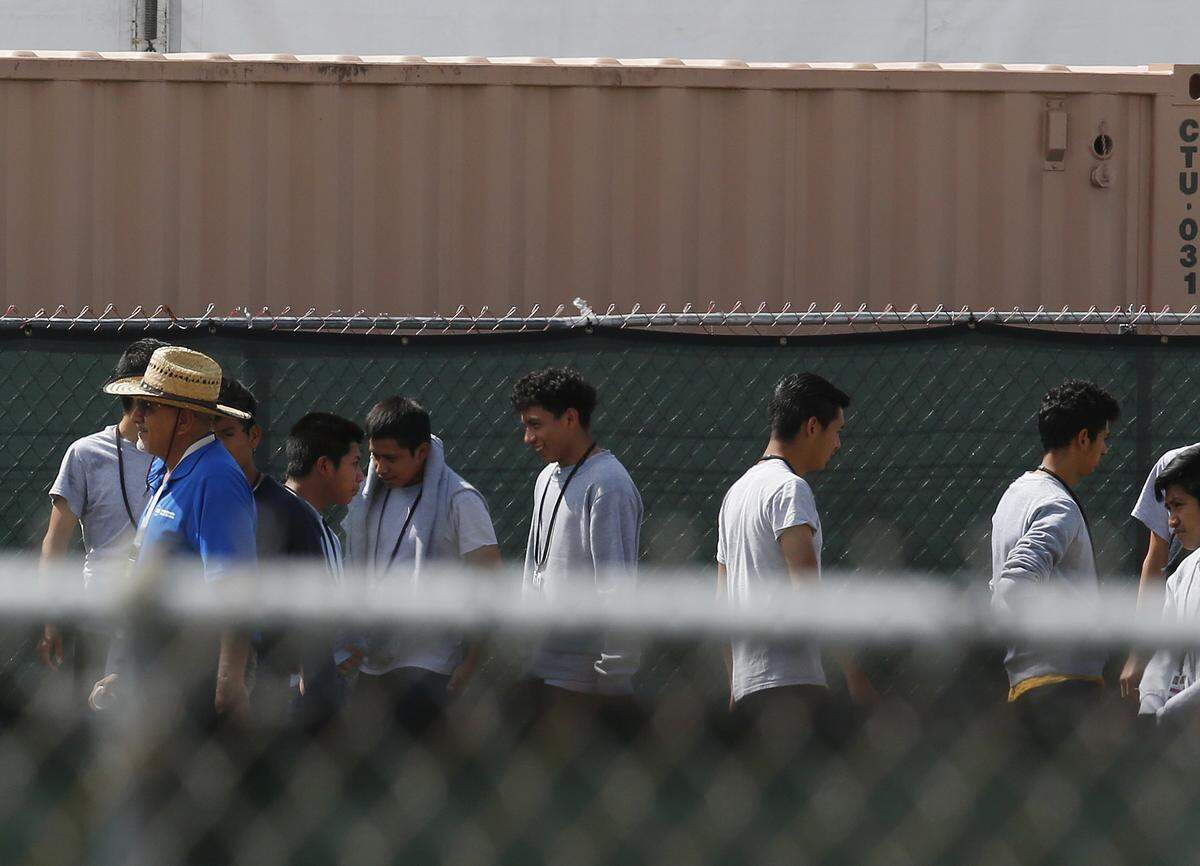 Migrant children walk outside at the Homestead Temporary Shelter for Unaccompanied Children a former Job Corps site that now houses them, on Friday, June 22, 2018. U.S. officials provided a glimpse into the South Florida facility housing more than 1,000 teen-age migrants, seeking to dispel any suggestions that children are being mistreated.