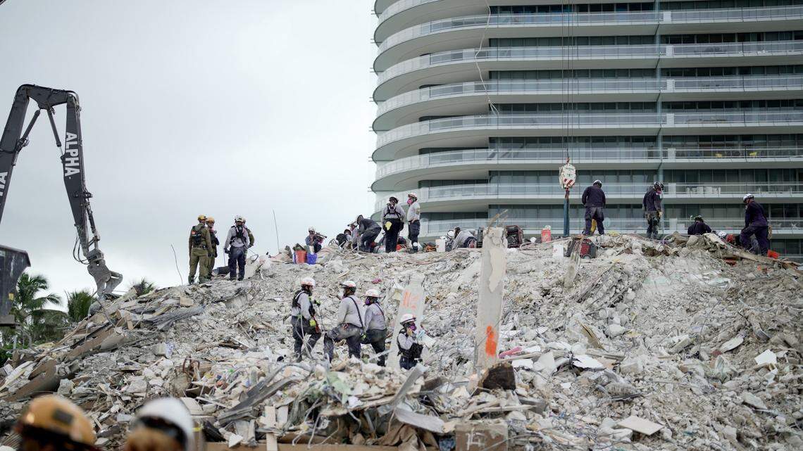 Rescue workers searched the rubble of the collapsed Champlain Towers South condo last summer in Surfside. Last week, attorneys announced a nearly $1 billion settlement in lawsuits over the tragedy.