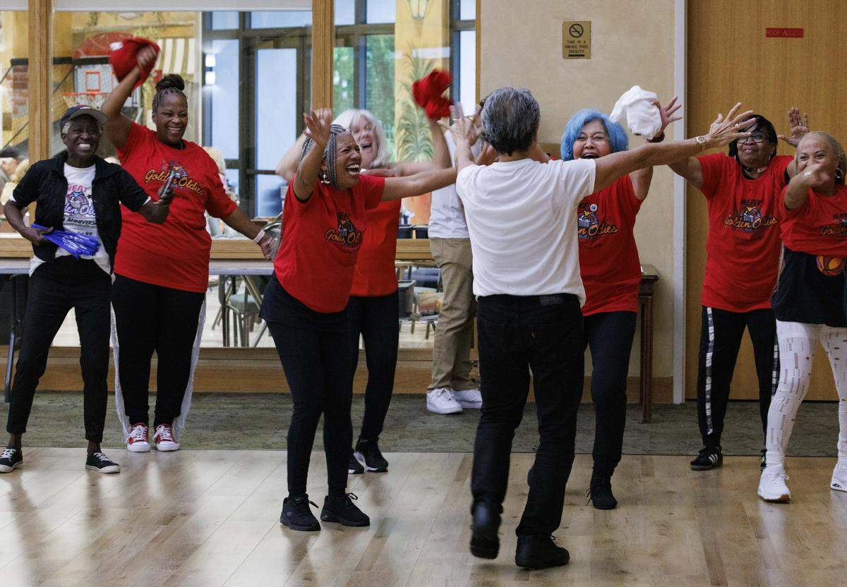 Cliff Lui, center, hugs his new team members during the HEAT Golden Oldies auditions for the Miami Heat senior dance team on Thursday, Sept. 25, 2025, at Southwest Focal Point Community Center in Pembroke Pines, Fla.