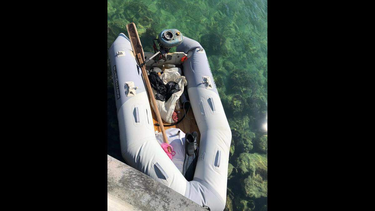 An inflatable dinghy abuts a sea wall in Key West Sunday, May 15, 2022. The small boat was used by Cuban migrants to travel to the United States, according to the Border Patrol.