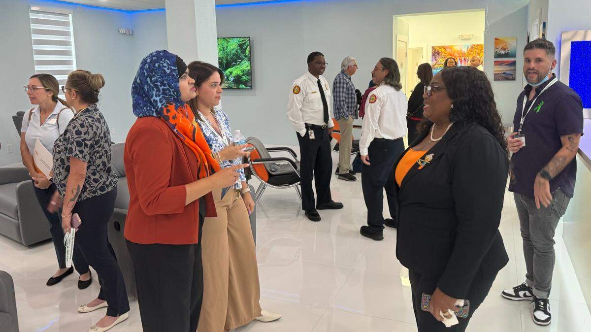Nusrat Karim, director of The Living Room, and Portia Newbold Knight, chief commercial officer at New Horizons Community Health Center, give people a tour of the new Living Room facility that will offer a variety of services to help people experiencing a mild mental health crisis on Wednesday, May 1, 2024.