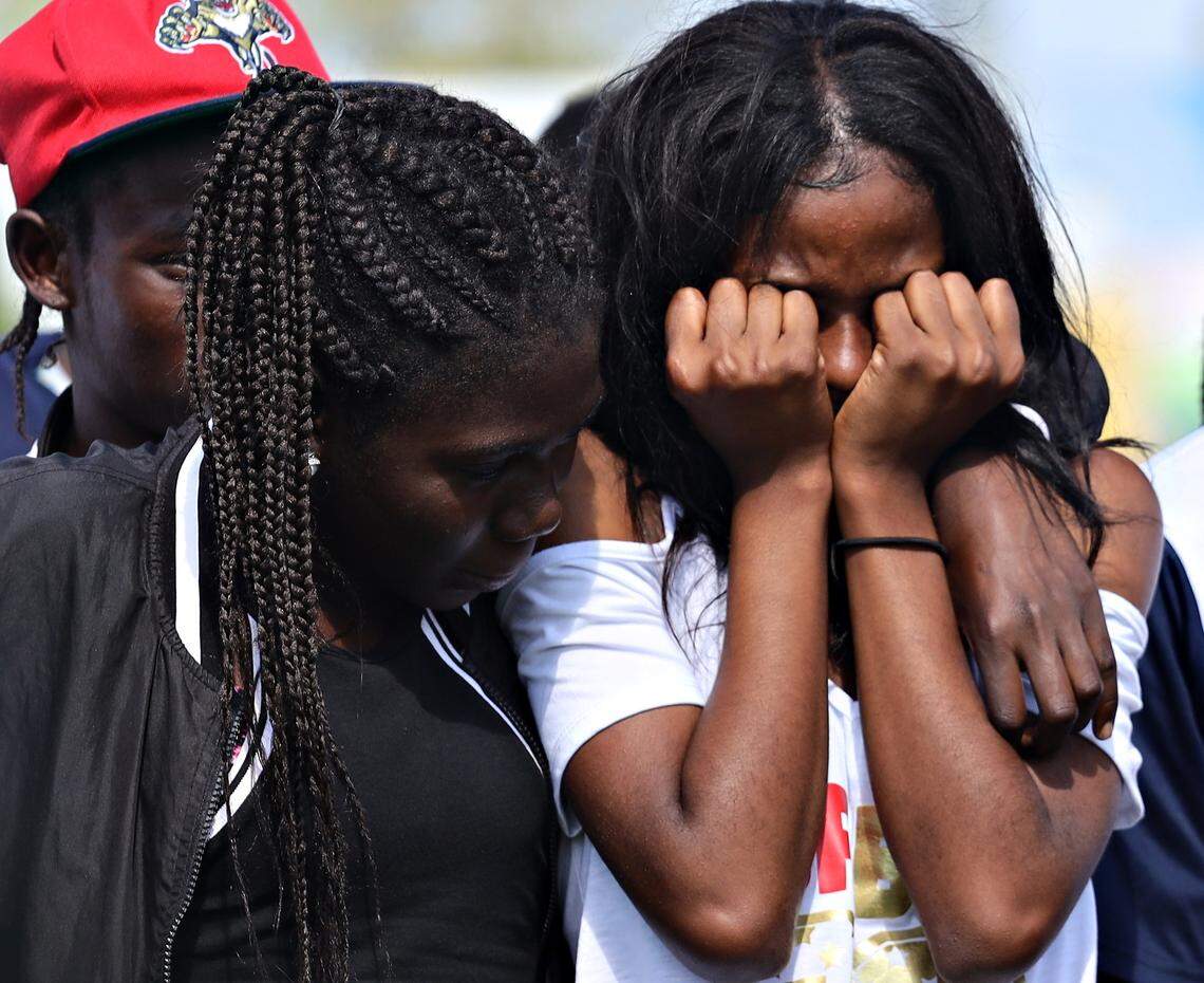 Nineline Dumezile, 17, right, is comforted by a teammate while she grieved as Little Haiti FC Soccer Club teammates gathered for a press conference regarding the deaths of three players at its home field on Monday, May 27, 2019 in Miami’s Little Haiti’s neighborhood.