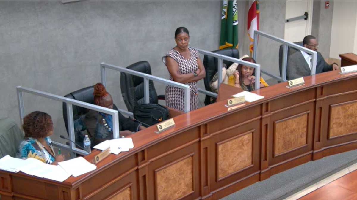 West Park Mayor Felicia Brunson stands with her arms crossed at the May 21 city commission meeting. City Commissioner Katrina Touchstone alleges in a recently filed lawsuit that Brunson improperly ends meetings abruptly for political reasons.