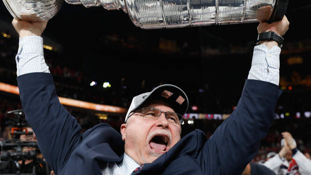 Head coach Barry Trotz of the Washington Capitals celebrates with the Stanley Cup after his team defeated the Vegas Golden Knights in Game 5. He would resign 11 days later and was a free agent available to all - until Thursday.