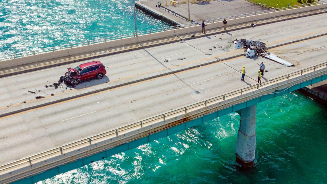 One dead, five injured after plane crashes on Haulover bridge, hits car and catches fire