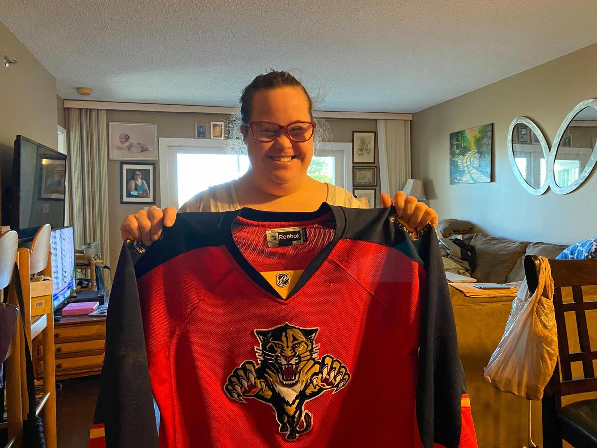 Taylor Quinones shows off her Florida Panthers jersey.