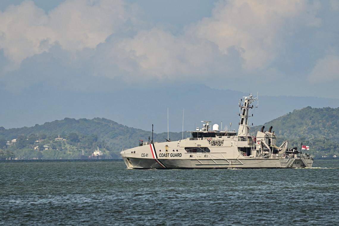 A Trinidad and Tobago Coast Guard (CG 41) vessel escorts the USS Gravely, a U.S. Navy warship, as it departs from Port of Spain, the capital of Trinidad and Tobago, on Oct. 30, 2025. The warship arrived there a few days before, one of several U.S. warships that have been amassing in the Caribbean Sea near northern Venezuela since August
