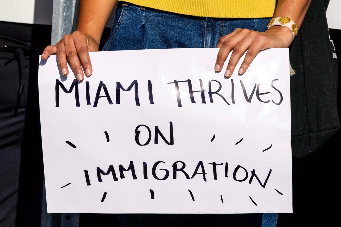 A Demonstrator holds a sign that reads “MIAMI THRIVES ON IMMIGRATION” during a press conference hosted by ACLU Florida, Florida Rising, The Florida Immigrant Coalition and Family Action Network Movement on Tuesday, June 17, 2025, in Miami, Fla.