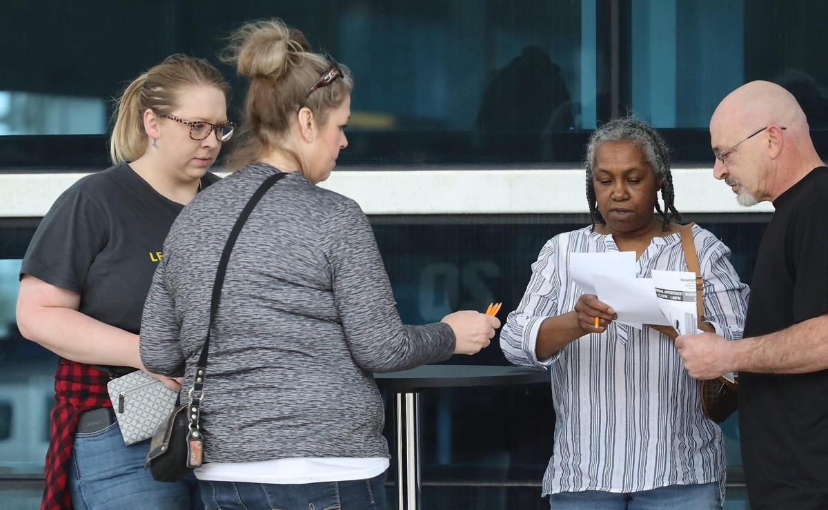 Cruisers fill out travel notice forms before boarding the Carnival Sensation on Monday, March 9, 2020, at PortMiami after cruise-related coronavirus transmission and a State Department warning.