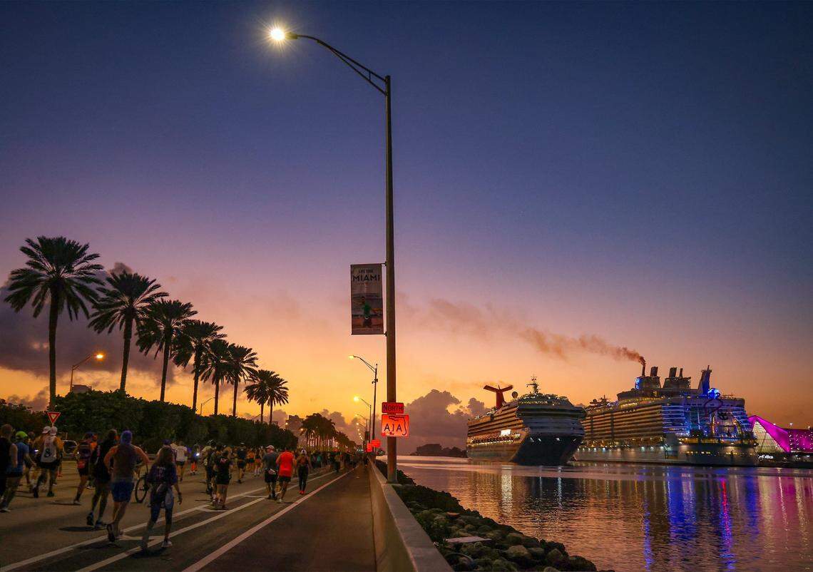 Runners run eastward as the Carnival Conquest enters Government Cut to dock at the Port of Miami during Life Time Miami Marathon on Sunday, January 28, 2024 in Miami, Florida.