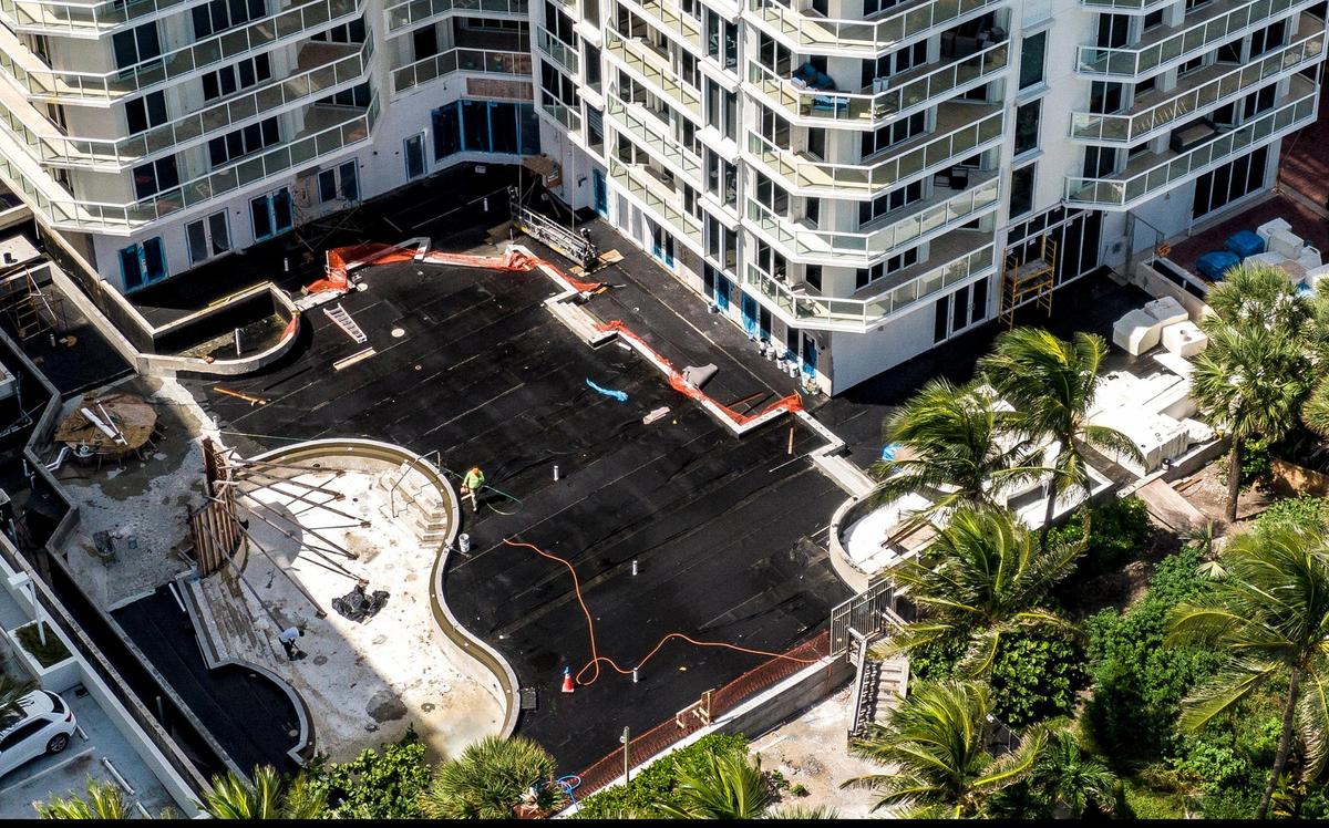 Black tarps cover the pool deck at the Mirage condo in Surfside. Cracking in the pool deck and the building’s connections to Champlain Towers South are cause for concern, engineering experts told the Miami Herald.