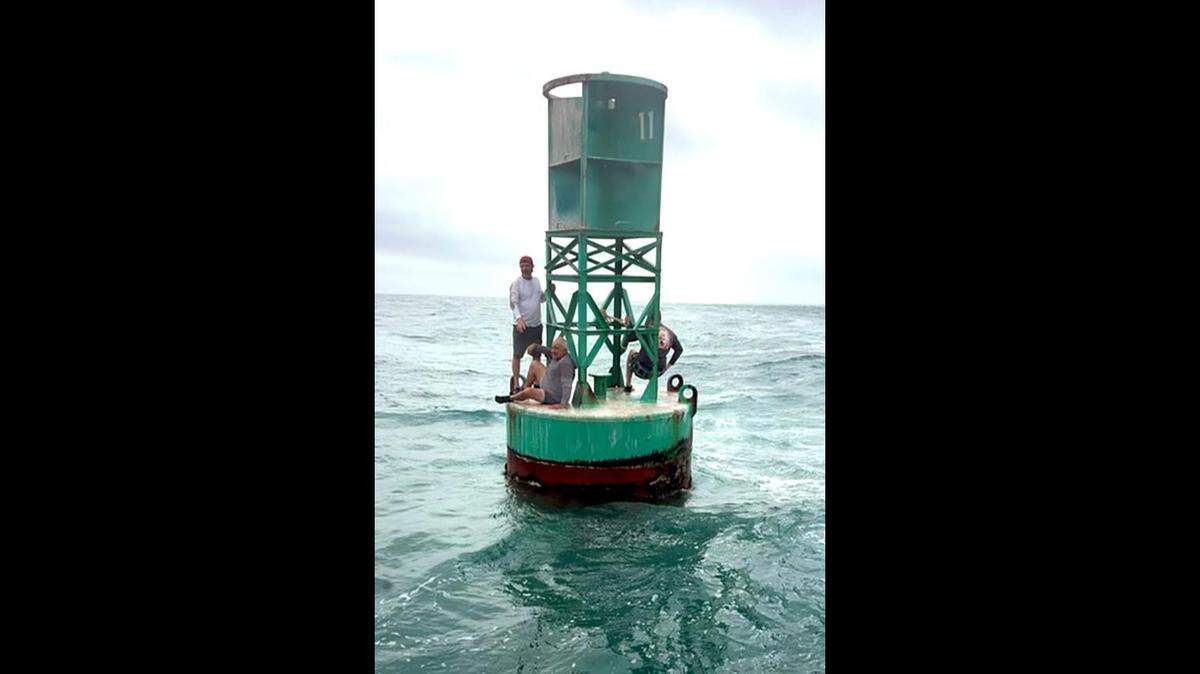 A Coast Guard Station boat crew rescued three people clinging to a buoy near Egmont Key from a 24-foot vessel that took on water in Tampa Bay on May 21, 2022.