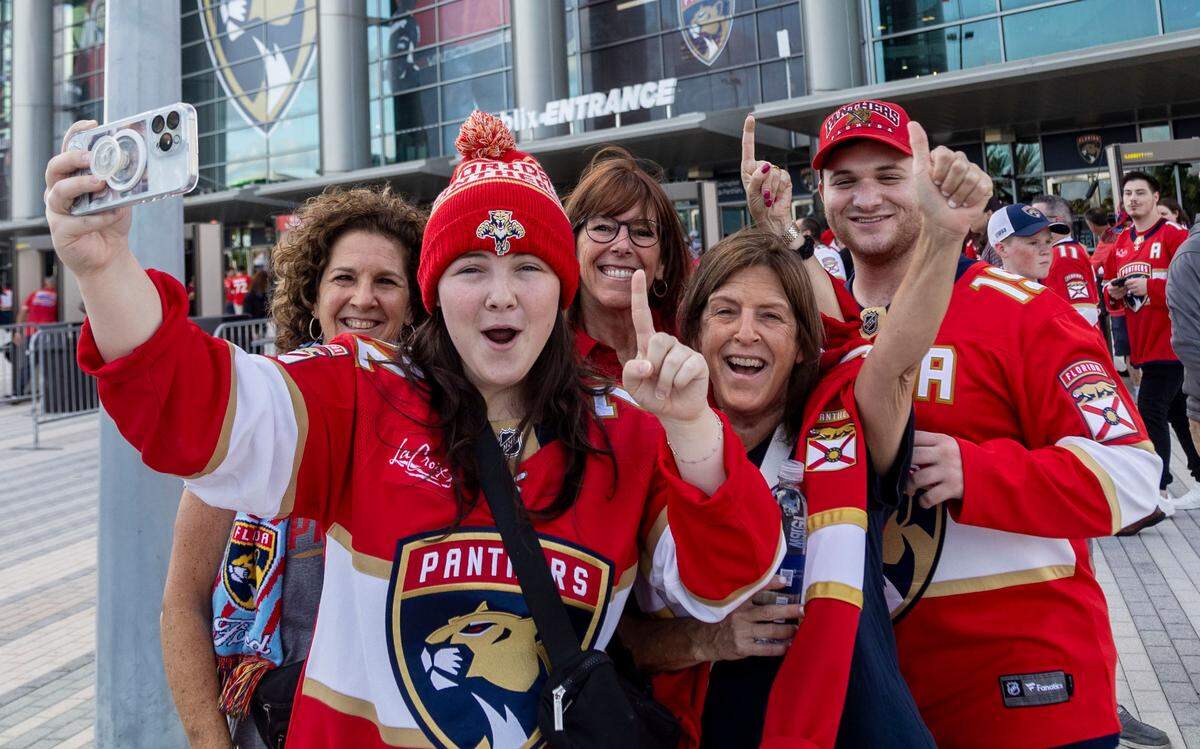 Members of the Chaikin family pose for a selfie in front of Amerant Bank Arena before the start of game 5.