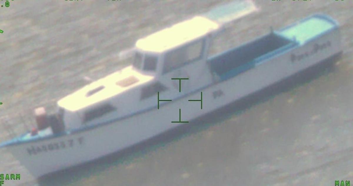 A large wooden fishing boat floats off the Marquesas Keys in the Lower Florida Keys Friday, Sept. 2, 2022. The Border Patrol said 45 people from Cuba arrived on the vessel.