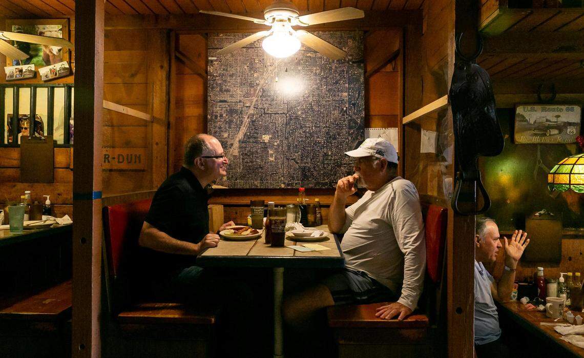 Michael Spivack, far left, and Gary Winston have a conversation as they visit Wagons West Restaurant on Friday, July 1, 2022, in Pinecrest, Fla.