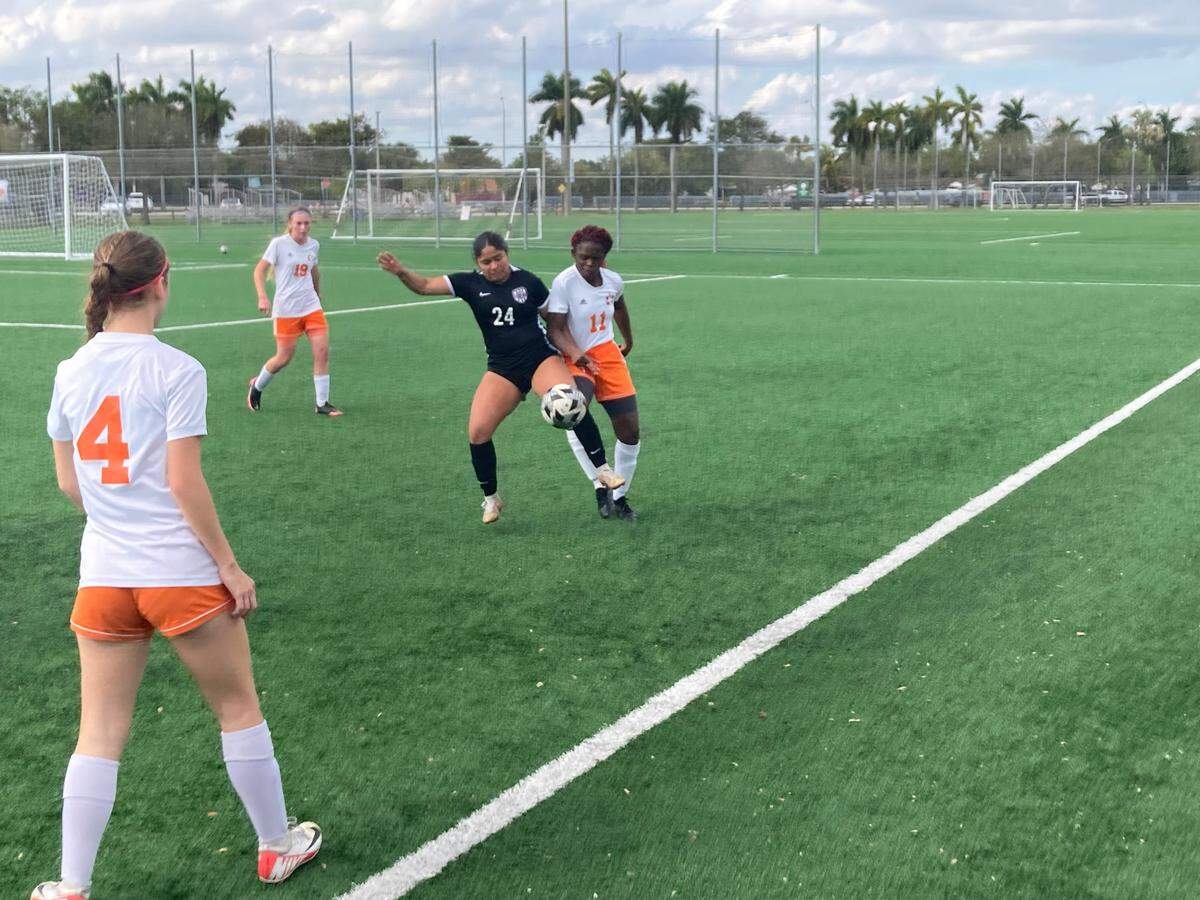 True North’s Aaliyah Perez battles South Florida HEAT’s Priscilla Cardichon for a loose ball during Wednesday’s Region 4-2A girls’ soccer final at Kendall Soccer Park.
