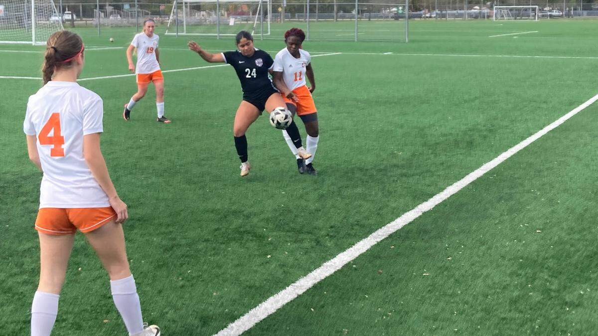 True North’s Aaliyah Perez battles South Florida HEAT’s Priscilla Cardichon for a loose ball during Wednesday’s Region 4-2A girls’ soccer final at Kendall Soccer Park.