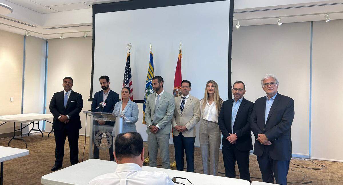Doral Mayor Christi Fraga stands with Josh Sayles of the Greater Miami Jewish Federation (left) and Miami Beach Commissioner David Suarez (right), to rescind an earlier resolution calling for peace in the Middle East and an end to all “hostilities” after facing backlash from the Jewish community.